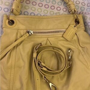 Coach purse made of genuine leather with removable crossbody strap.